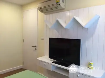 Modern bedroom with wall-mounted TV and air conditioning unit