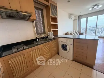 Modern kitchen with washing machine and open layout in city apartment