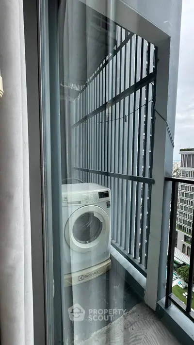 Modern balcony with washing machine overlooking urban landscape