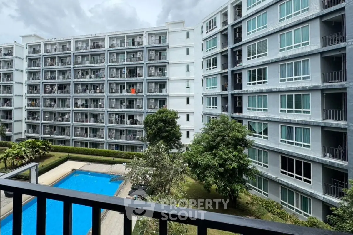 Modern apartment complex with pool and lush greenery, ideal for urban living.