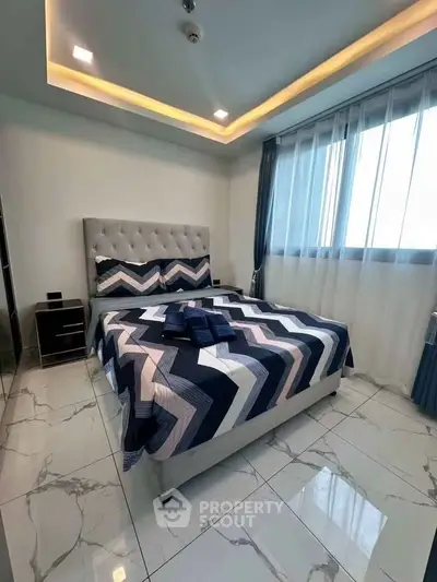 Modern bedroom with stylish decor and large window for natural light
