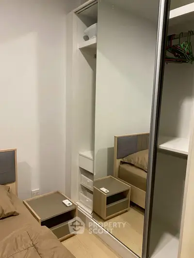 Modern bedroom with mirrored wardrobe and stylish furniture
