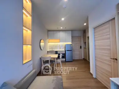 Modern apartment interior with open kitchen and cozy living area featuring wooden accents.
