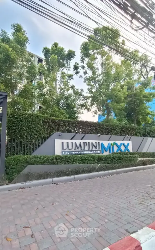 Modern Lumpini Mixx building exterior with lush greenery and clear signage.