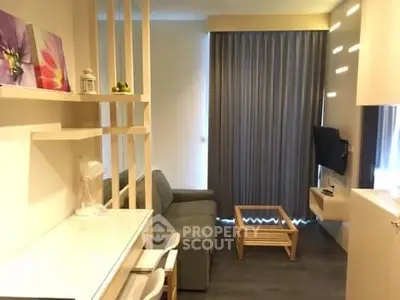 Modern living room with cozy sofa and wall-mounted TV, featuring stylish decor and natural light.