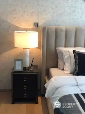 Luxurious bedroom with elegant bedside lamp and plush headboard