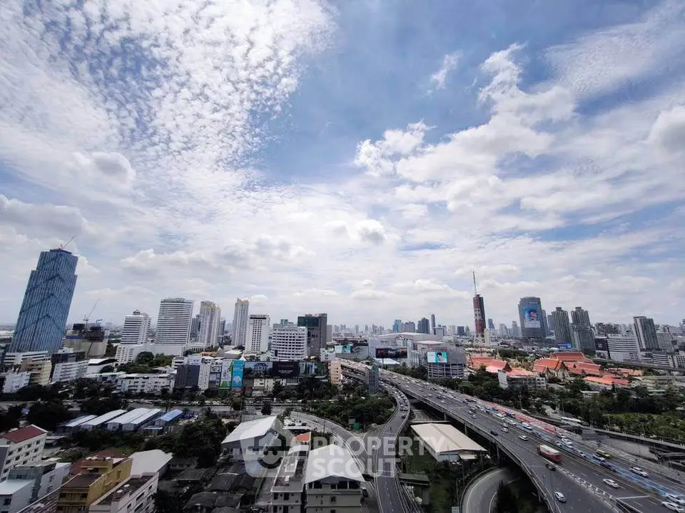 Stunning cityscape view showcasing urban skyline and highways under a vibrant sky.