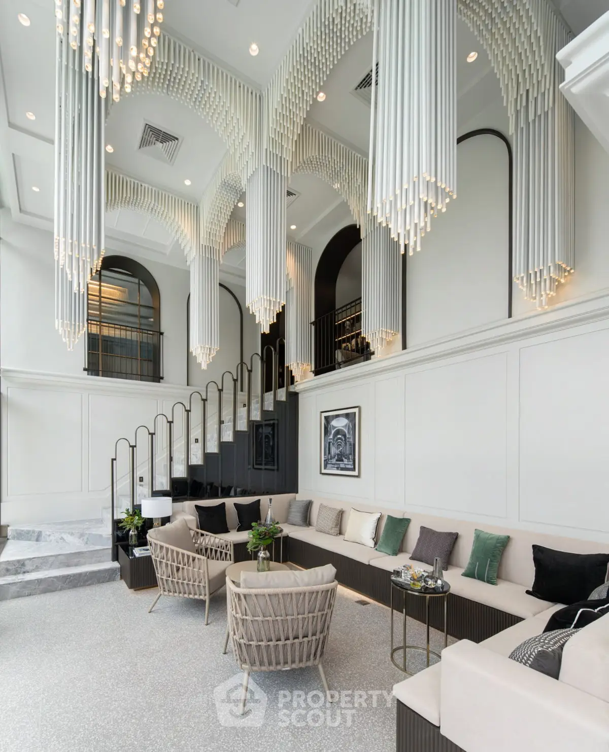 Luxurious living room with elegant chandeliers and modern decor in a high-end property.