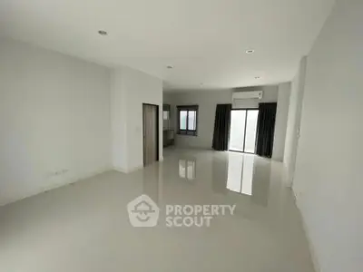 Spacious empty living room with large windows and modern flooring