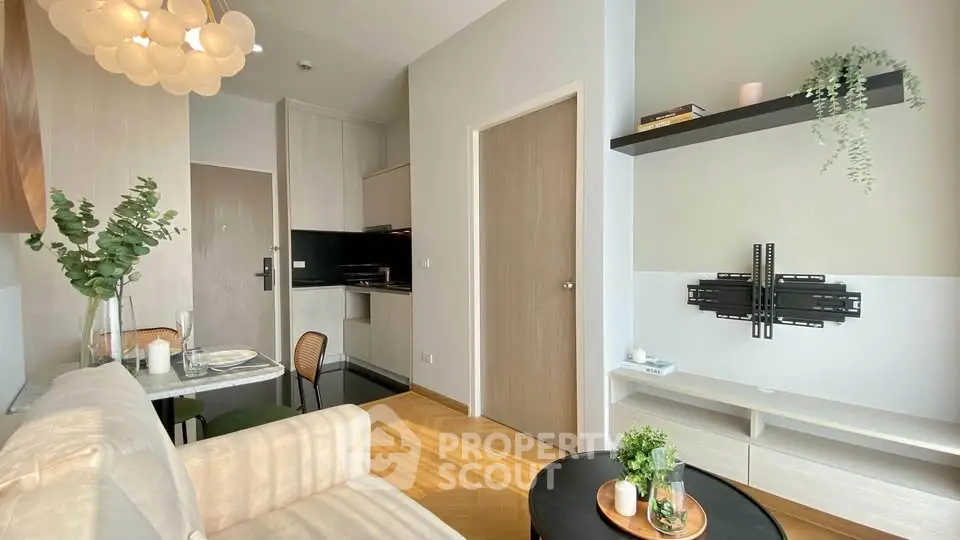 Modern living room with stylish decor and open kitchen layout in a cozy apartment.