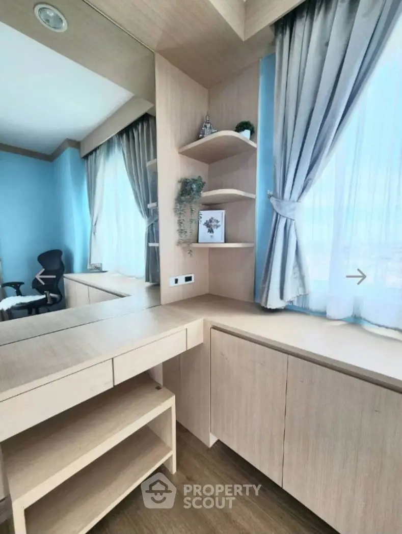 Modern study room with sleek wooden furniture and large windows for natural light.