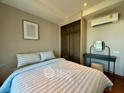 Modern bedroom with stylish decor and air conditioning in a cozy apartment.