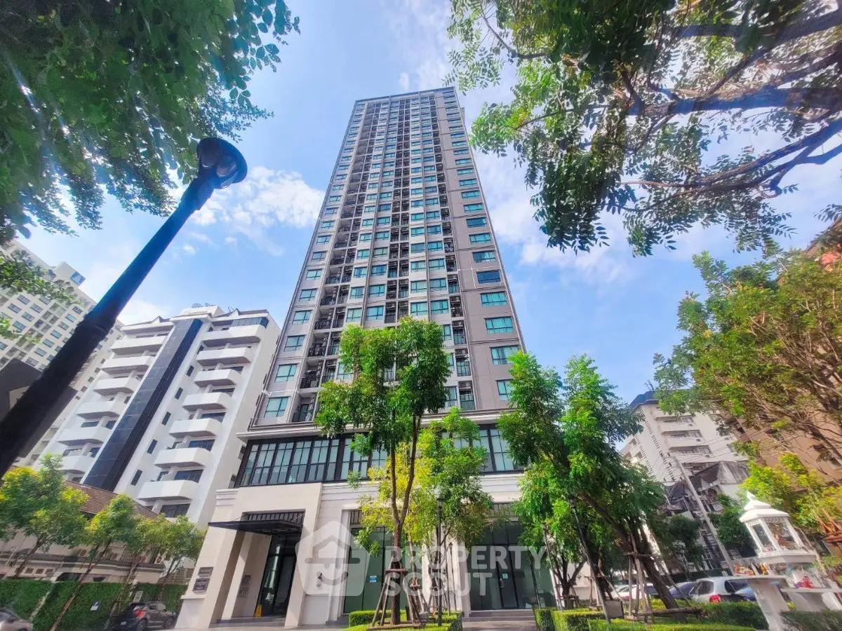 Stunning high-rise building with lush greenery and modern architecture in urban setting.