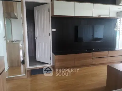 Modern living room with sleek wooden furniture and wall-mounted TV