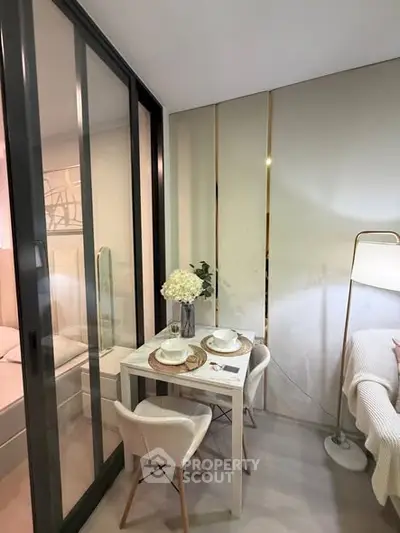 Modern studio apartment with glass partition and cozy dining area