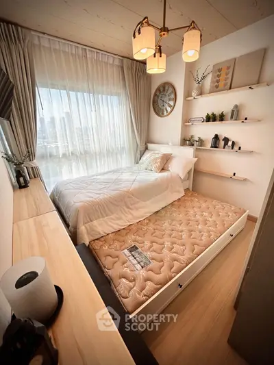 Cozy bedroom with pull-out bed and stylish decor, perfect for modern living.