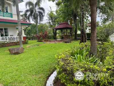 Charming garden with gazebo and lush greenery in a serene residential setting