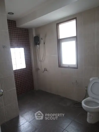 Spacious bathroom with modern shower and natural light