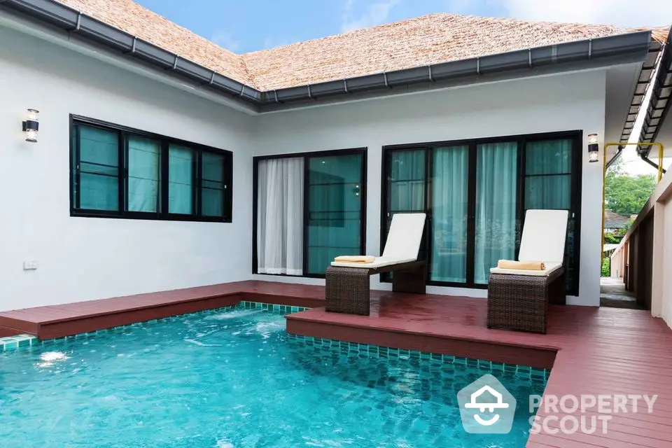 Luxurious villa with private pool and sun loungers, perfect for relaxation and leisure.