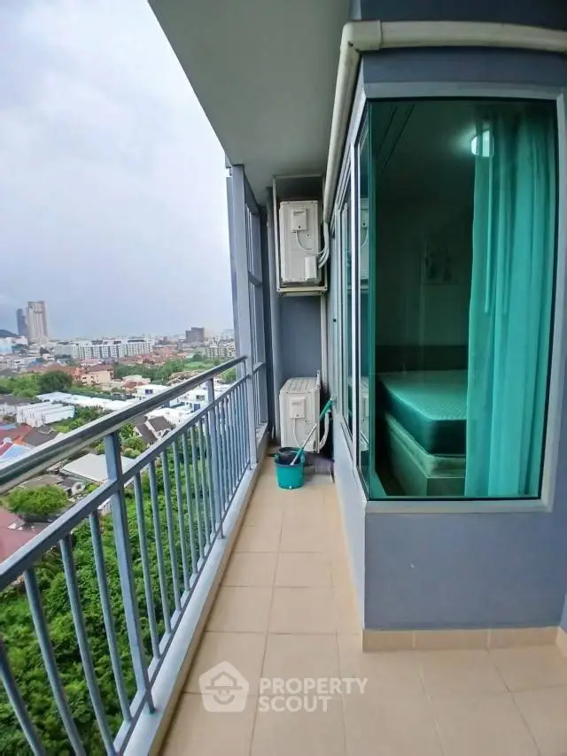 Spacious balcony with city view in modern high-rise apartment