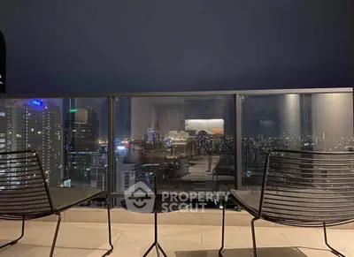 Stunning city view from a modern balcony with sleek seating, perfect for urban living.