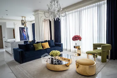 Luxurious living room with elegant decor, featuring a plush sofa, chic chandelier, and modern furniture.