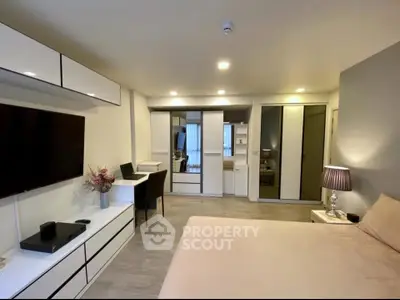 Modern bedroom with sleek furniture and built-in storage in a stylish apartment.