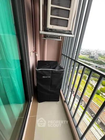 Compact balcony with air conditioning unit and city view, ideal for urban living.