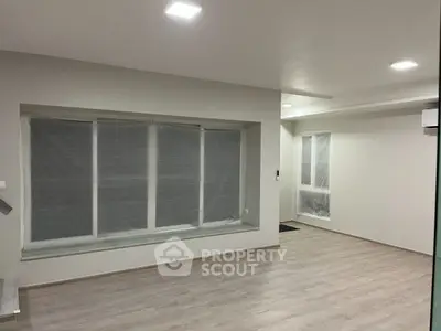 Spacious modern living room with large windows and sleek flooring