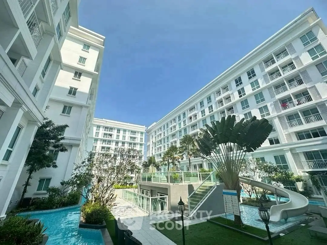 Luxurious apartment complex with pool and lush landscaping