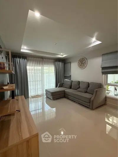 Spacious living room with modern decor and large windows for natural light.