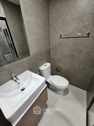 Modern bathroom with sleek fixtures and neutral tile design