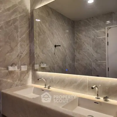Luxurious bathroom with double sinks and elegant marble tiles