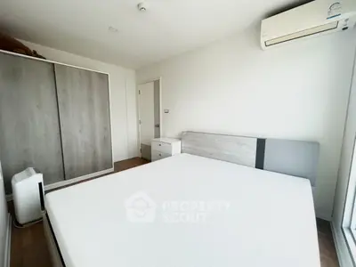 Modern minimalist bedroom with air conditioning and sleek wardrobe