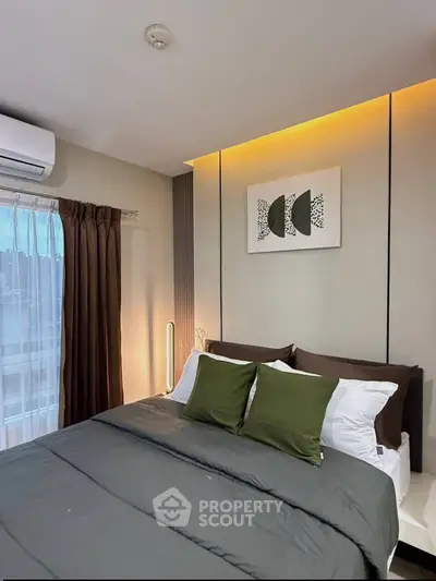 Modern bedroom with stylish decor and ambient lighting, featuring a comfortable bed and elegant wall art.
