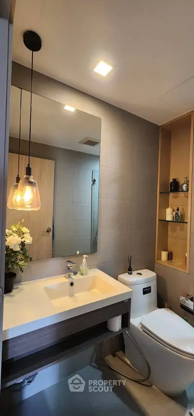 Modern bathroom with sleek fixtures and ambient lighting, featuring a stylish vanity and contemporary decor.