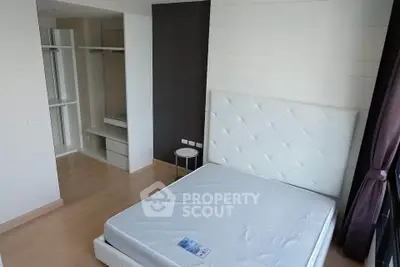 Spacious bedroom with modern design and walk-in closet in a luxury apartment.
