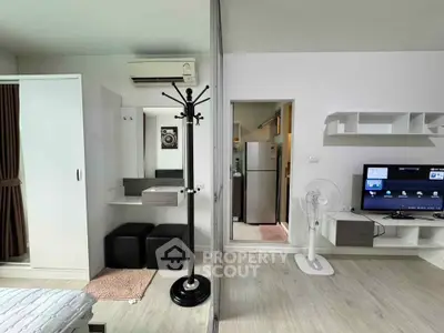 Modern studio apartment with sleek interior design, featuring a cozy living area and efficient storage solutions.