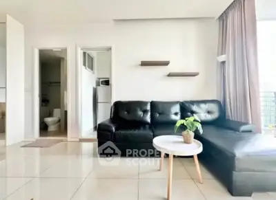 Modern living room with sleek black leather sofa and stylish decor in bright apartment