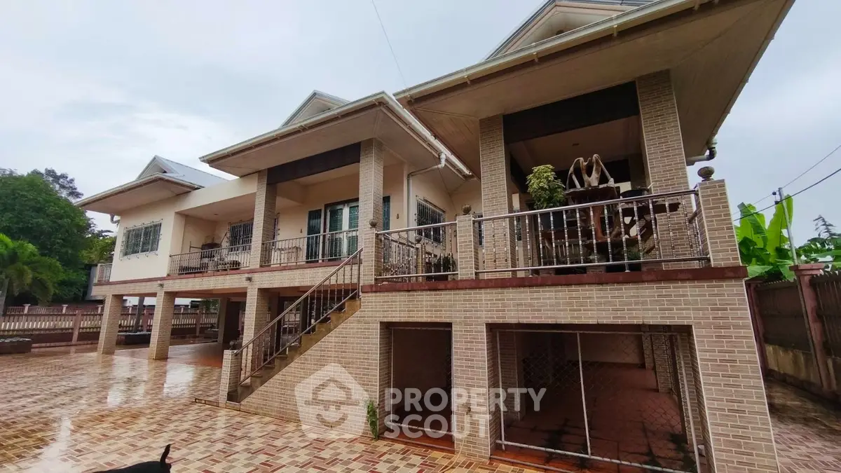 Stunning two-story brick house with spacious balcony and elegant exterior design.