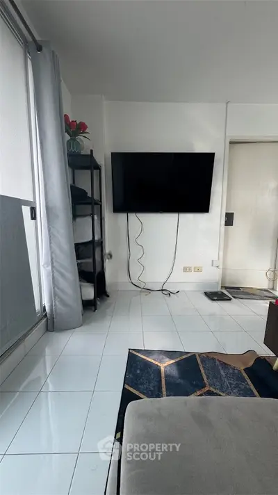Modern living room with wall-mounted TV and sleek decor