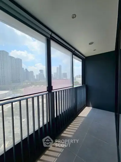 Spacious balcony with stunning city skyline view, perfect for relaxation and enjoying urban living.
