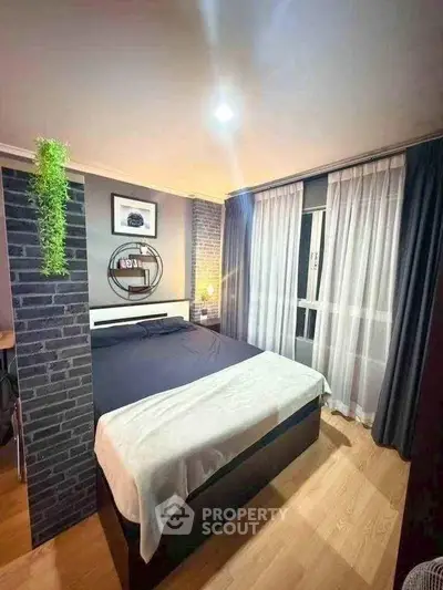 Modern bedroom with stylish decor and natural light, featuring a cozy bed and elegant curtains.