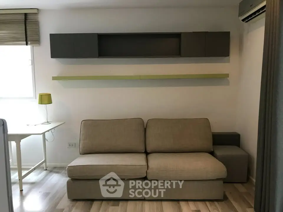 Modern living room with stylish sofa and wall-mounted shelves