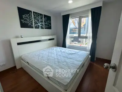Modern bedroom with large window and stylish decor in urban apartment