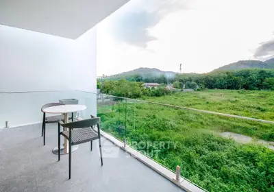 Spacious balcony with stunning green view, perfect for relaxation and outdoor dining.