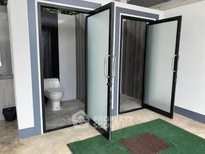 Modern bathroom with frosted glass doors and sleek design