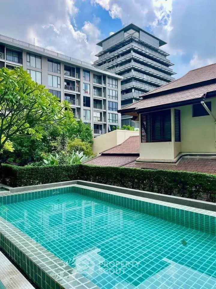 Luxurious residential complex with private pool and lush greenery, perfect for serene urban living.
