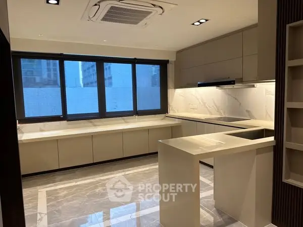 Luxurious modern kitchen with sleek countertops and ample natural light.