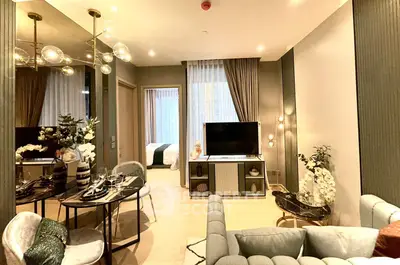 Luxurious modern living room with elegant decor and open view to bedroom